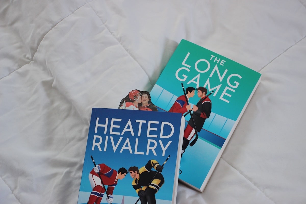 Heated Rivalry and The Long Game by author Rachel Reid on a white background.